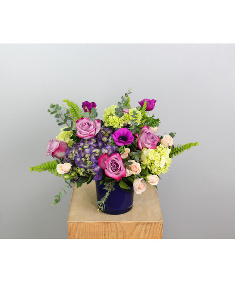 Amethyst Allure is a breathtaking floral arrangement that captivates with its rich jewel-toned hues and elegant textures. 