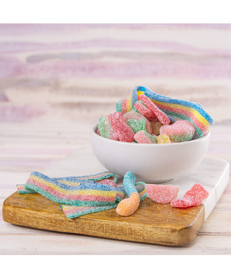 An assortment of your favorite sour candies – sour power belts, sour kids, sour watermelon and sour worms.