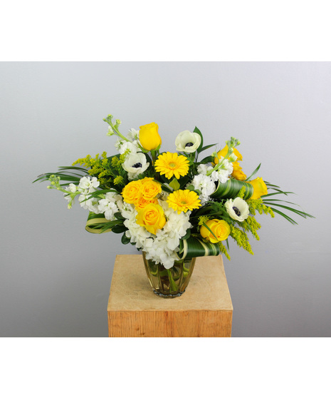 Sun Kissed is a radiant floral arrangement that captures the warmth and glow of a sunlit day.